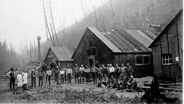 A group of men in front of buildings in Camp 44, wpH109