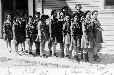 Brownies standing on the side walk of the Community Hall, wpH500