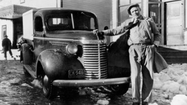 Man and truck in front of building to the right of the Sunset Theatre, wpH632