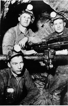 Three men in an underground shaft, wpH434